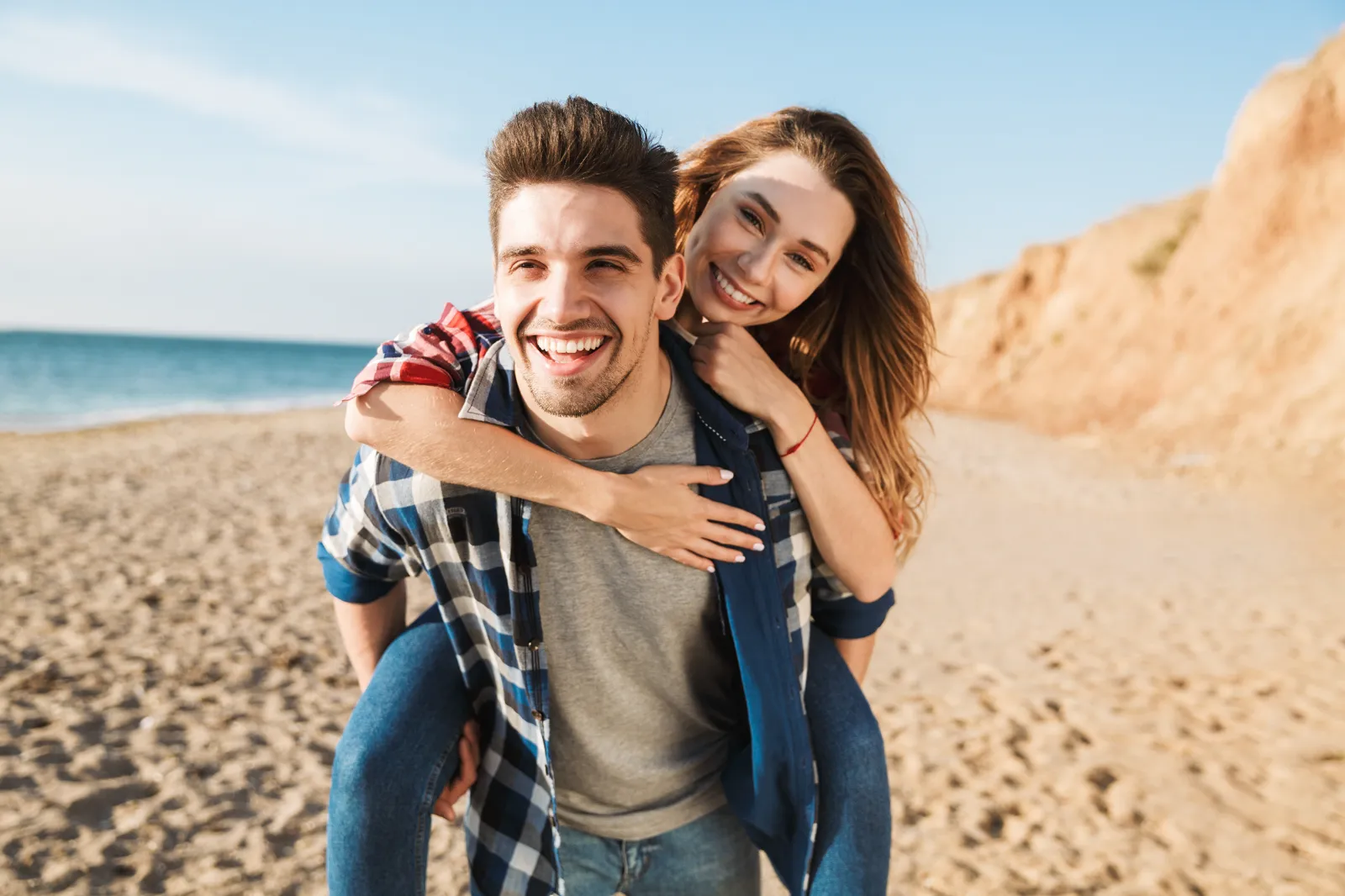 Couple smiling outdoors after teeth whitening with Dr. Scott J. Pettinato, DMD